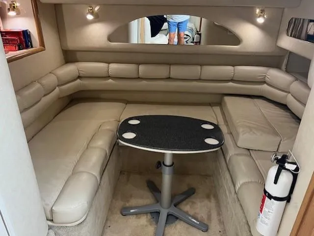  Yacht Photos Pics Interior of a 1997 Sea Ray 400 Sundancer with beige seating and a small table.