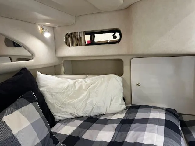  Yacht Photos Pics Cozy cabin interior of 1997 Sea Ray 400 Sundancer with plaid bedding and soft lighting.