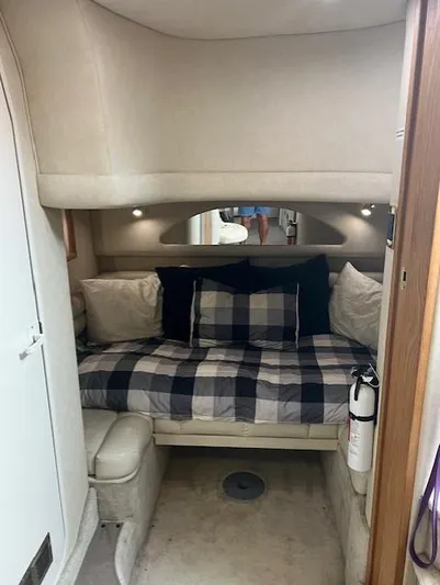  Yacht Photos Pics Cozy cabin interior of 1997 Sea Ray 400 Sundancer with plaid bedding and ambient lighting.