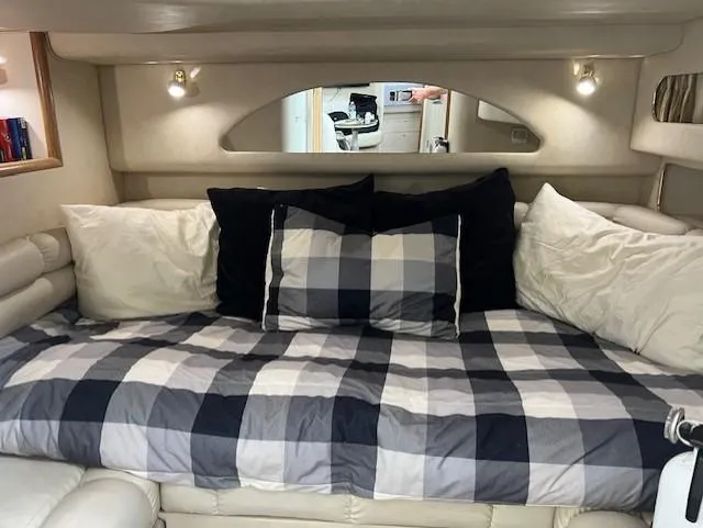  Yacht Photos Pics Interior of 1997 Sea Ray 400 Sundancer with cozy bed and checkered bedding.