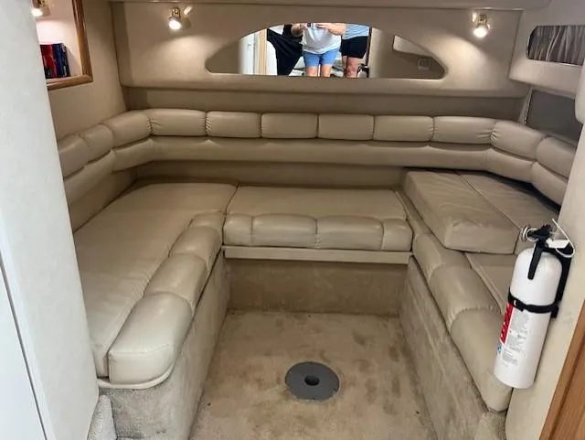  Yacht Photos Pics 1997 Sea Ray 400 Sundancer interior with beige leather seating and fire extinguisher.
