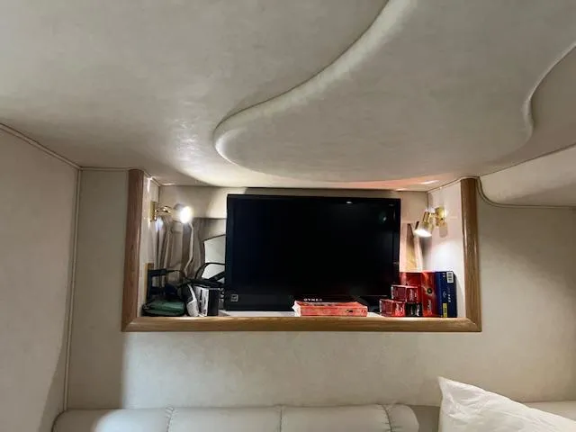  Yacht Photos Pics Interior of 1997 Sea Ray 400 Sundancer with TV and shelves in cozy cabin space.