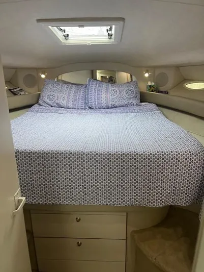  Yacht Photos Pics Cozy bedroom interior of 1997 Sea Ray 400 Sundancer yacht with patterned bedding.