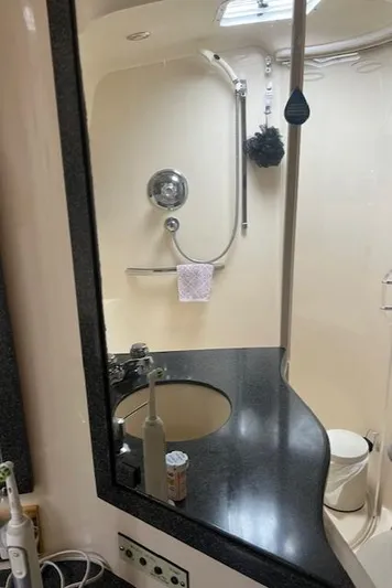  Yacht Photos Pics Bathroom interior of 1997 Sea Ray 400 Sundancer yacht with modern fixtures and mirror.