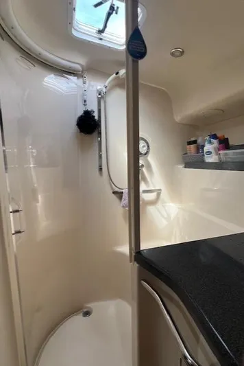  Yacht Photos Pics Bathroom interior of 1997 Sea Ray 400 Sundancer yacht, featuring shower and storage.