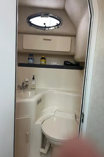  Yacht Photos Pics Bathroom interior of 1997 Sea Ray 400 Sundancer yacht, featuring sink and toilet.