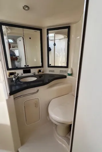  Yacht Photos Pics Bathroom interior of 1997 Sea Ray 400 Sundancer yacht, featuring sink and toilet.