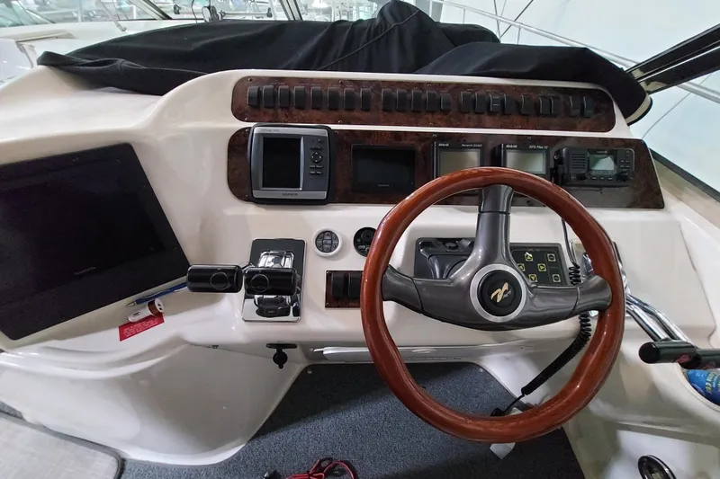  Yacht Photos Pics Cockpit of 1997 Sea Ray 400 Sundancer with steering wheel and navigation controls.