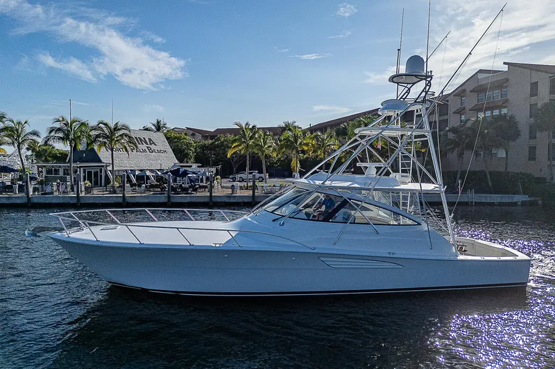  Yacht Photos Pics 2023 Viking 54 Open yacht cruising in a sunny marina.