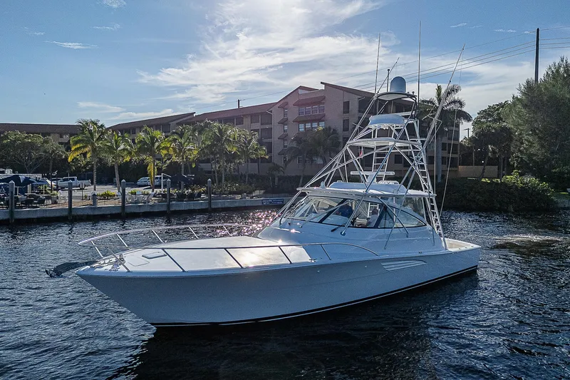  Yacht Photos Pics 2023 Viking 54 Open yacht cruising near a marina.