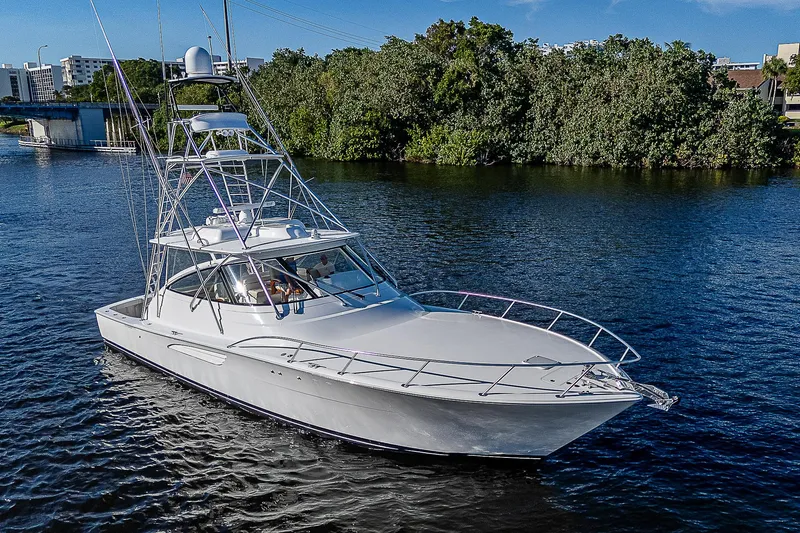  Yacht Photos Pics 2023 Viking 54 Open yacht cruising on a serene river.