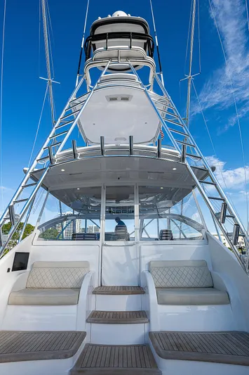  Yacht Photos Pics 2023 Viking 54 Open yacht with tower, luxurious seating, and clear blue sky.
