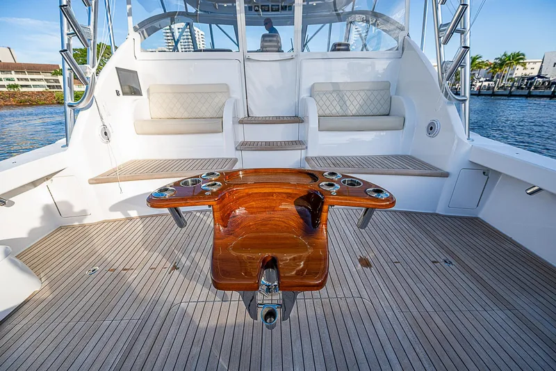  Yacht Photos Pics 2023 Viking 54 Open yacht deck with seating and polished wood table.