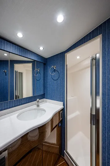  Yacht Photos Pics Modern bathroom in 2023 Viking 54 Open yacht with blue walls and sleek fixtures.