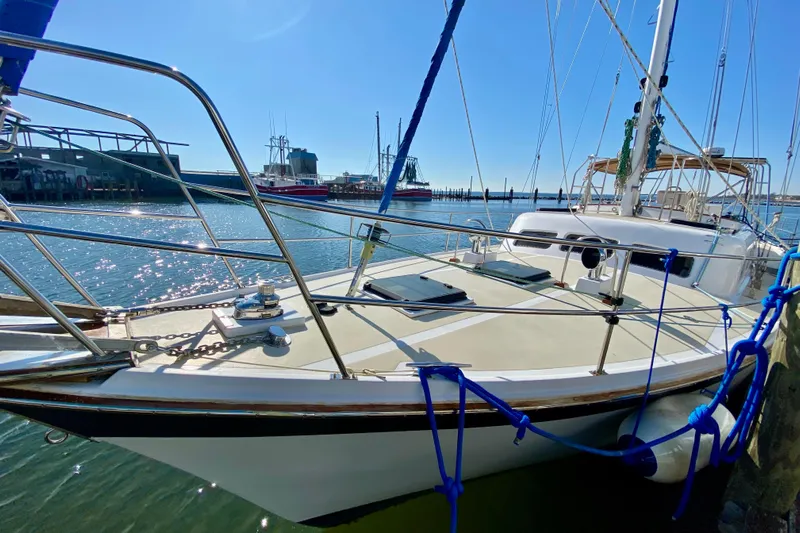 Wonder Yacht Photos Pics 1980 Wellington 44 sailboat docked in sunny marina, showcasing deck and rigging.