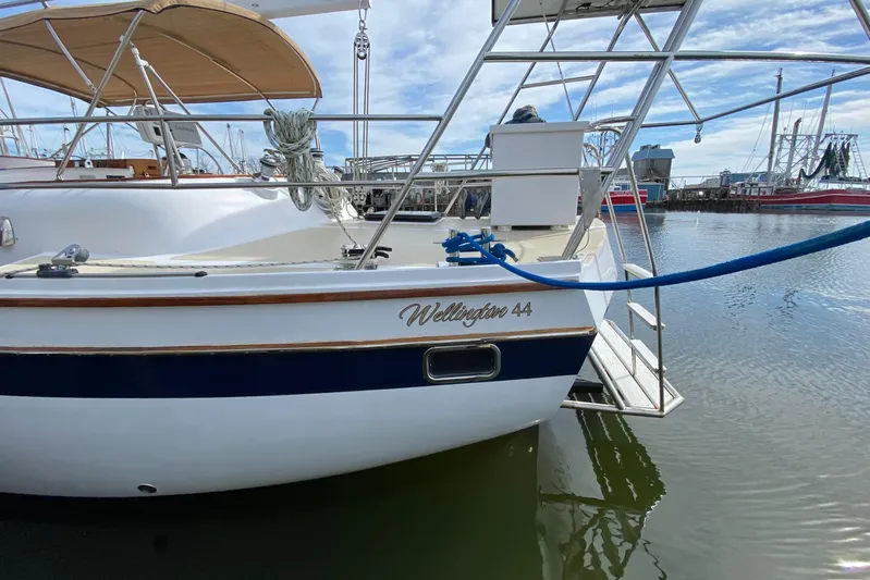 Wonder Yacht Photos Pics 1980 Wellington 44 sailboat docked in marina, featuring elegant design and blue accents.