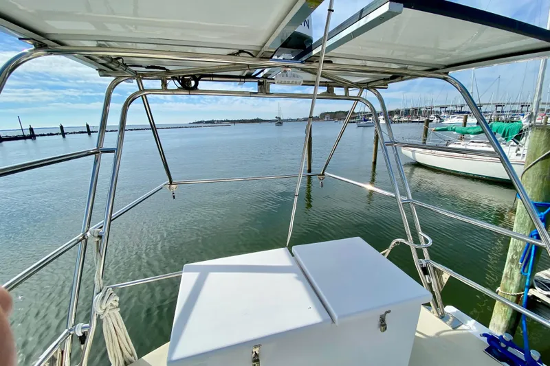 Wonder Yacht Photos Pics 1980 Wellington 44 sailboat cockpit view, marina background, calm waters, clear sky.