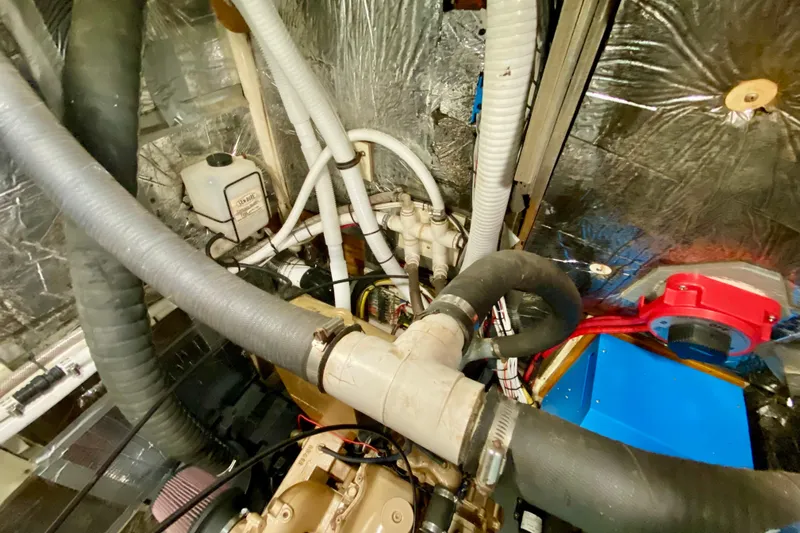 Wonder Yacht Photos Pics Engine room of 1980 Wellington 44 yacht with hoses and mechanical components.