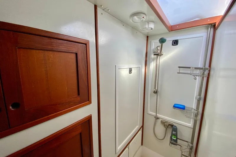 Wonder Yacht Photos Pics 1980 Wellington 44 yacht bathroom with wooden cabinets and modern shower fixtures.