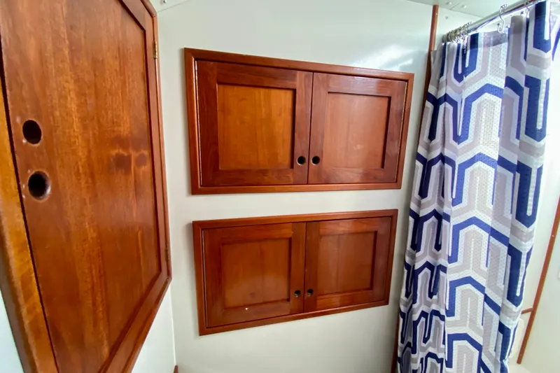 Wonder Yacht Photos Pics Wooden cabinets and geometric shower curtain in 1980 Wellington 44 interior.