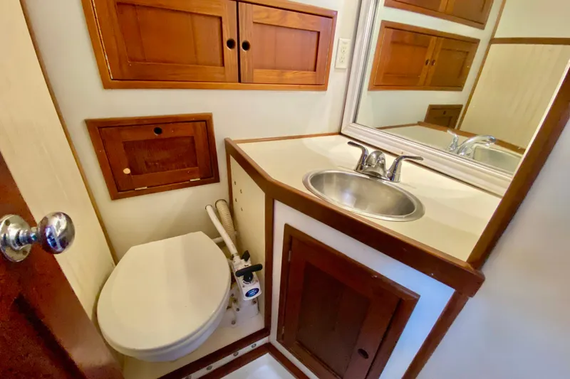 Wonder Yacht Photos Pics Compact bathroom in 1980 Wellington 44 yacht with wooden cabinets and stainless steel sink.