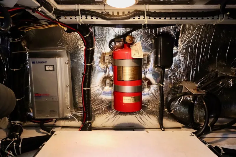 Grace Wins II Yacht Photos Pics Engine room of 2001 Carver 406 Motor Yacht with fire extinguisher and electrical components.