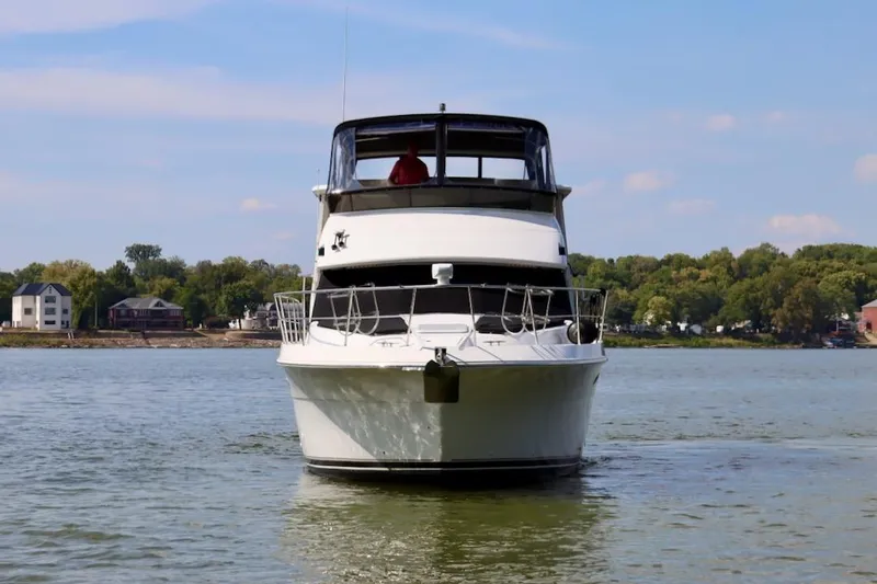 Grace Wins II Yacht Photos Pics Front view of a 2001 Carver 406 Motor Yacht on a calm lake.