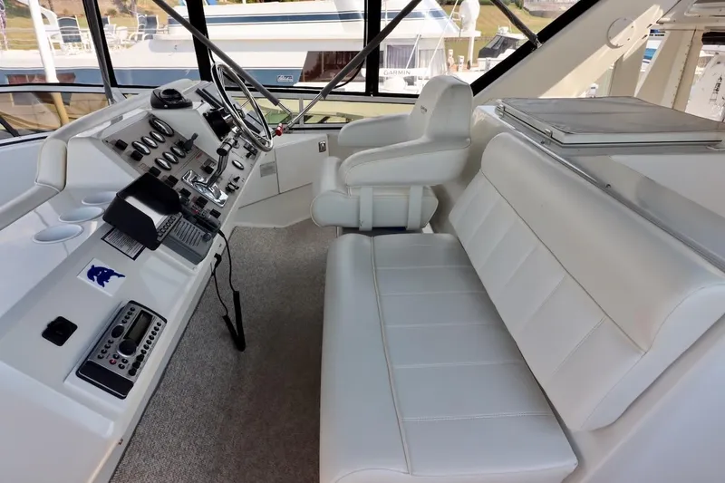 Grace Wins II Yacht Photos Pics Interior of 2001 Carver 406 Motor Yacht with white seating and control panel.