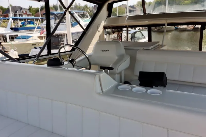 Grace Wins II Yacht Photos Pics Interior of 2001 Carver 406 Motor Yacht with helm and seating area.