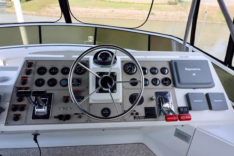 Grace Wins II Yacht Photos Pics Helm of 2001 Carver 406 Motor Yacht with steering wheel and Raymarine navigation system.