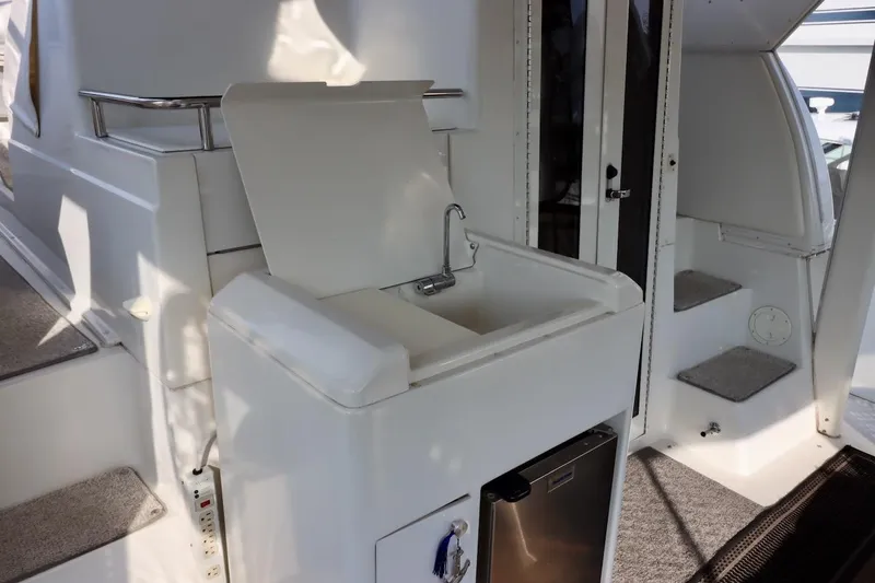 Grace Wins II Yacht Photos Pics 2001 Carver 406 Motor Yacht interior with sink and mini fridge.