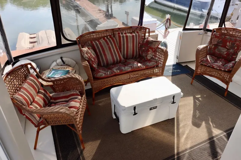 Grace Wins II Yacht Photos Pics Cozy seating area on 2001 Carver 406 Motor Yacht with wicker furniture and cooler.