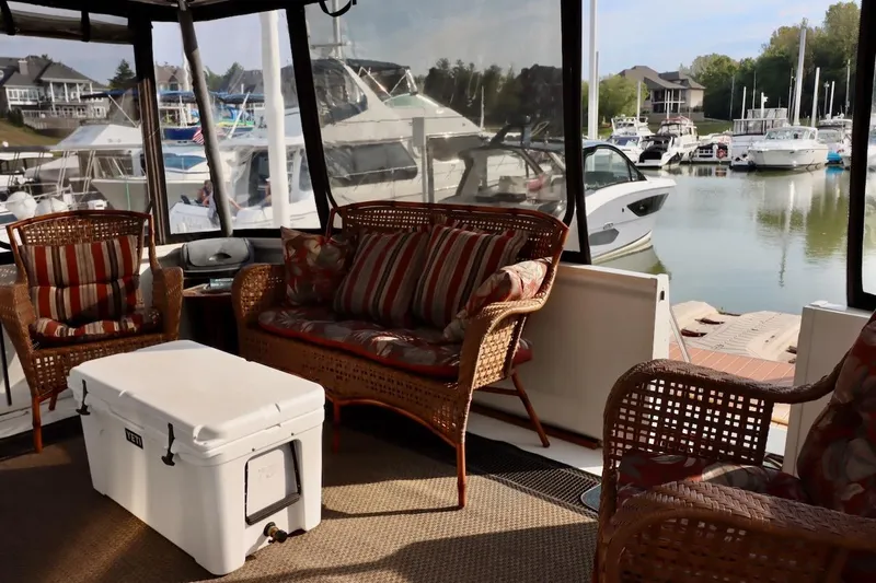 Grace Wins II Yacht Photos Pics Interior of 2001 Carver 406 Motor Yacht with wicker seating and marina view.