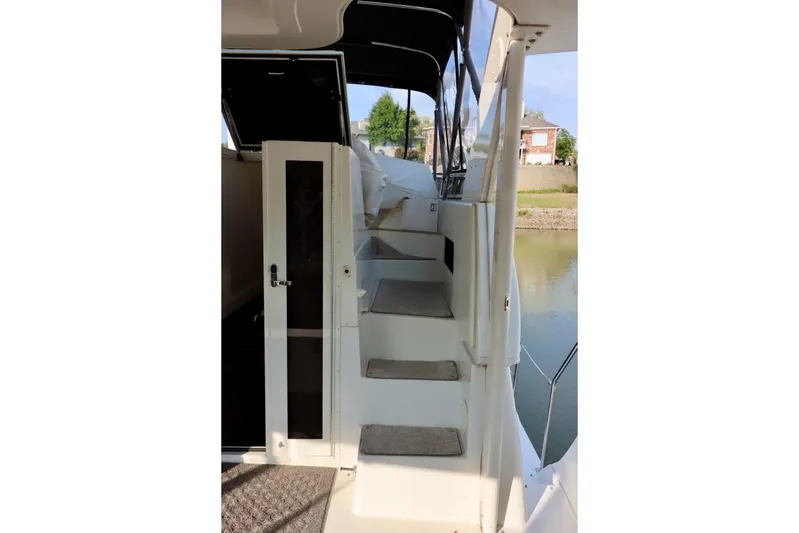 Grace Wins II Yacht Photos Pics Staircase on 2001 Carver 406 Motor Yacht, leading to upper deck with water view.