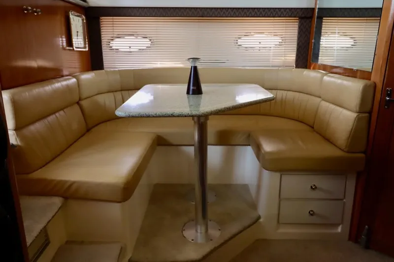 Grace Wins II Yacht Photos Pics Luxurious interior of 2001 Carver 406 Motor Yacht with beige leather seating and table.