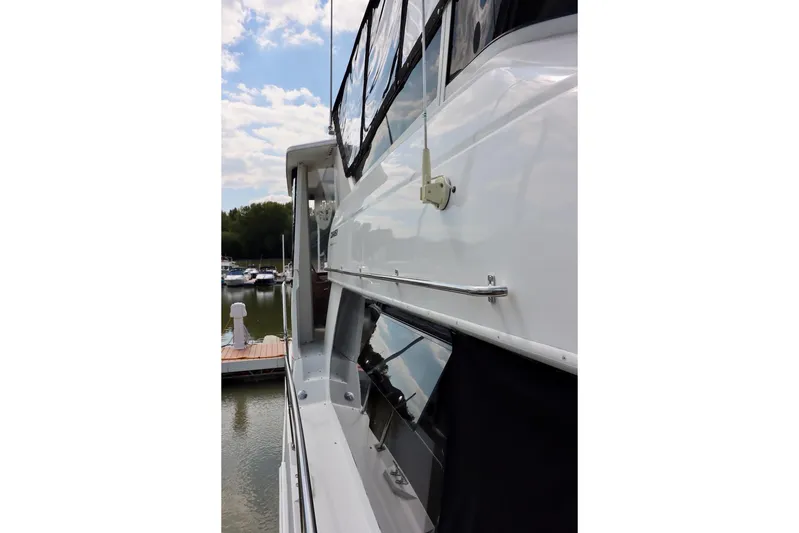 Grace Wins II Yacht Photos Pics Side view of a 2001 Carver 406 Motor Yacht docked at a marina.