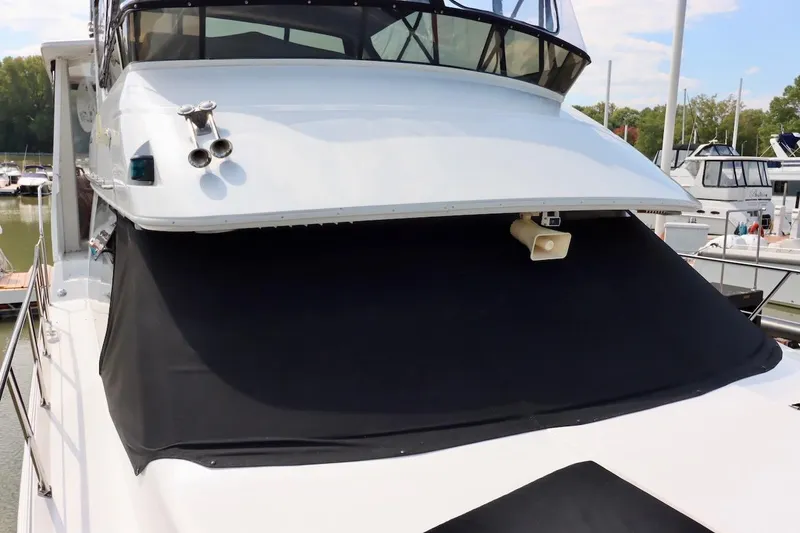 Grace Wins II Yacht Photos Pics 2001 Carver 406 Motor Yacht with black cover docked at marina.