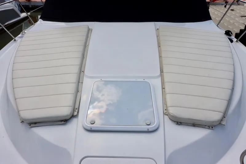 Grace Wins II Yacht Photos Pics 2001 Carver 406 Motor Yacht deck with cushioned seating and hatch.