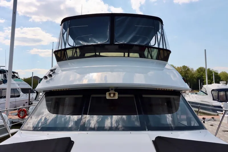 Grace Wins II Yacht Photos Pics 2001 Carver 406 Motor Yacht docked at marina under blue sky.
