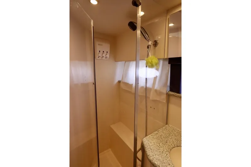 Grace Wins II Yacht Photos Pics Shower area in 2001 Carver 406 Motor Yacht with modern fixtures and granite countertop.