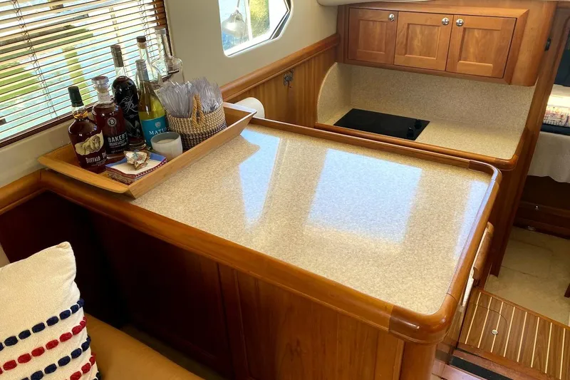 Hellion Yacht Photos Pics Interior of 2005 Mainship 34 Trawler with wooden cabinetry and countertop.