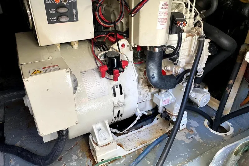 Hellion Yacht Photos Pics Engine room of a 2005 Mainship 34 Trawler, showcasing mechanical components and wiring.