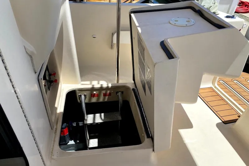 Hellion Yacht Photos Pics 2005 Mainship 34 Trawler engine compartment with open hatch and visible ladder.