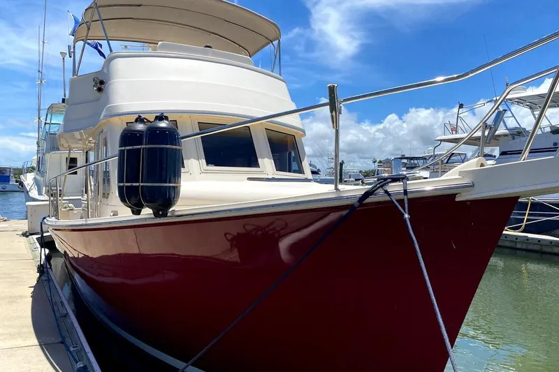 Hellion Yacht Photos Pics 2005 Mainship 34 Trawler docked at marina under clear blue sky.