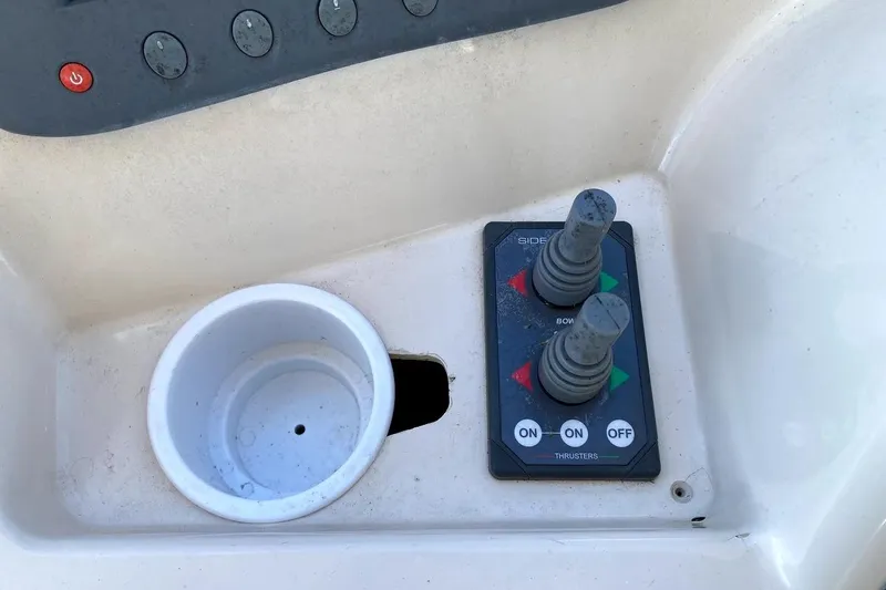 Hellion Yacht Photos Pics Control panel of a 2005 Mainship 34 Trawler with joystick thrusters and cup holder.