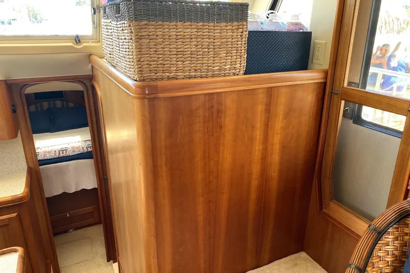 Hellion Yacht Photos Pics 2005 Mainship 34 Trawler interior with wooden cabinetry and woven basket storage.