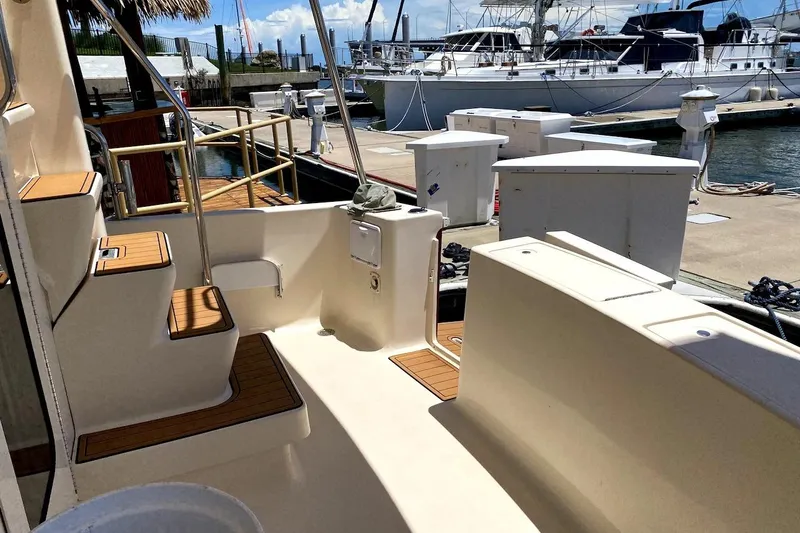 Hellion Yacht Photos Pics 2005 Mainship 34 Trawler docked, showcasing deck and marina view.