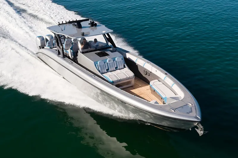  Yacht Photos Pics Midnight Express 43' Open boat cruising on clear blue water, showcasing sleek design and speed.