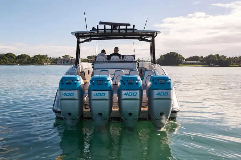  Yacht Photos Pics Midnight Express 43' Open boat with four powerful engines on calm water.