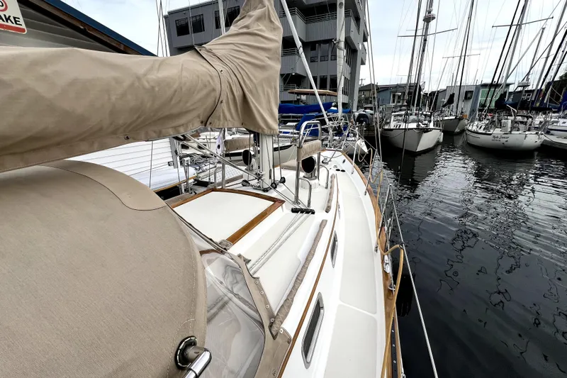  Yacht Photos Pics Sailboat docked in marina, Pacific Seacraft 31, 2004 model, with beige covers.